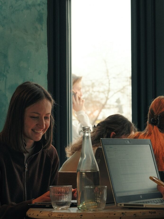 Hotel Revenue Manager Job Description: Free Template, Duties & Interview Test 1 Young professionals studying with laptops at a cafe