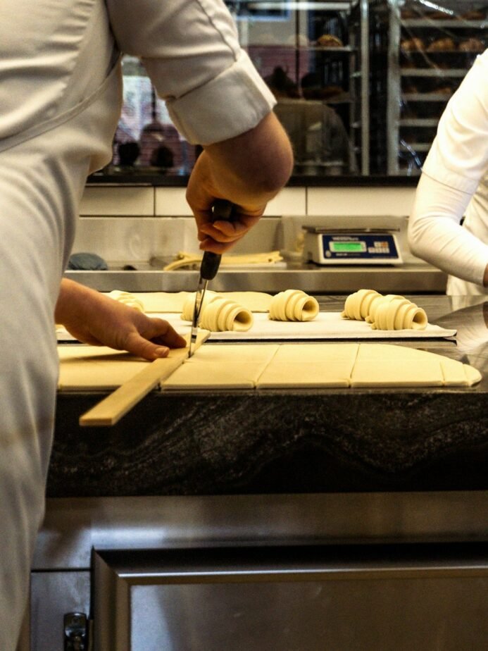 Bakery Supervisor Job Description: Free Template, Duties & Hiring Test 1 Bakery chefs preparing pastry dough in a professional kitchen