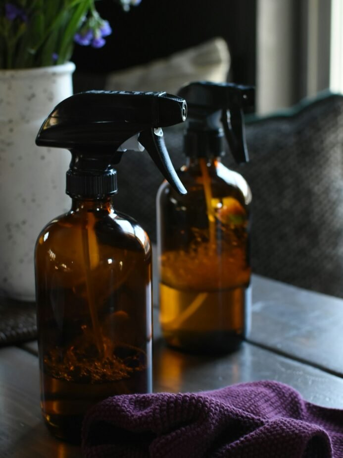 Cleaning spray bottles on wooden table