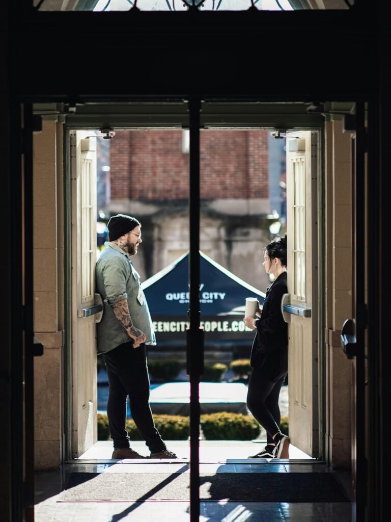 Two people speaking at an entrance during guest arrival