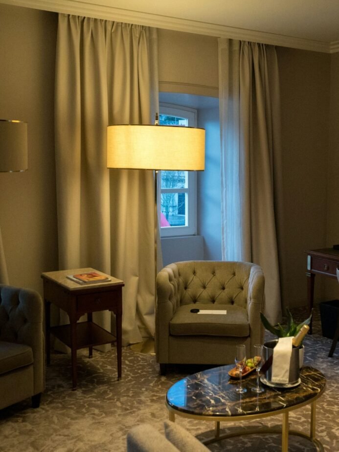 Well-lit hotel guest room with desk