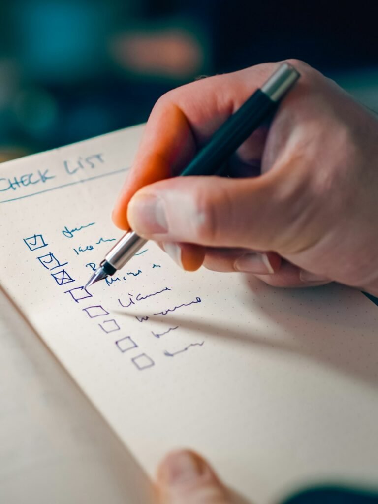 Hand writing a checklist in a notebook