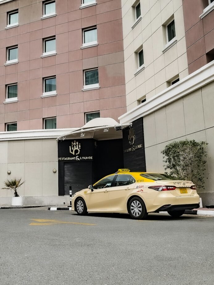 Hotel Airport Pickup SOP: Transfer Register & Driver Checklist 1 Yellow taxi waiting outside a hotel entrance