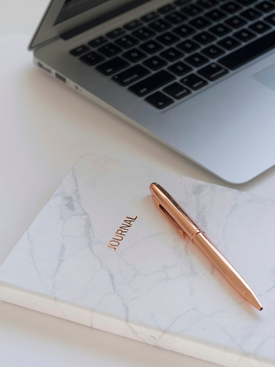 Notebook and laptop on a desk