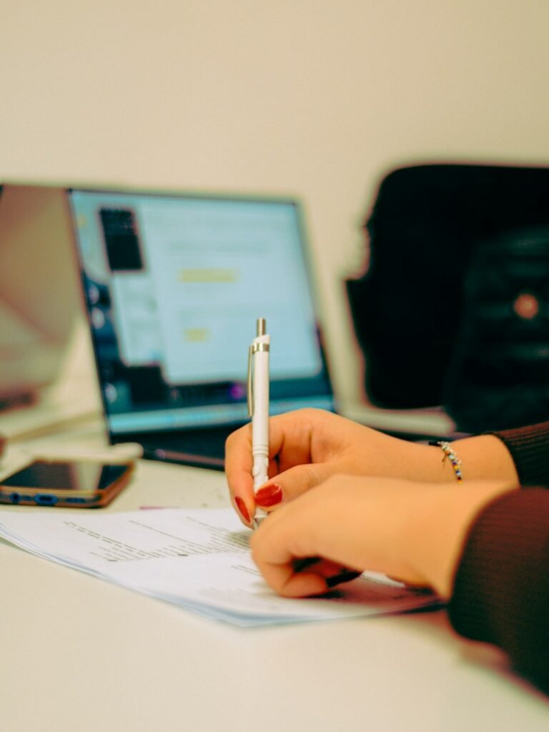 Professional writing a document at a desk