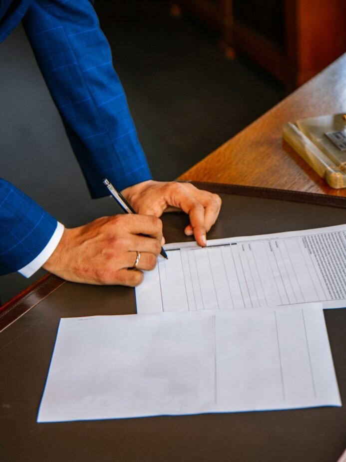 Hotel OTA Commission Reconciliation: Invoice Matching & SOP 1 Person filling an official paper form