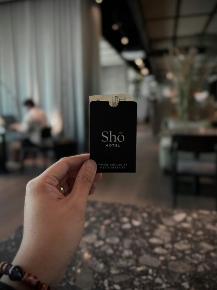 Hand holding a hotel room key card