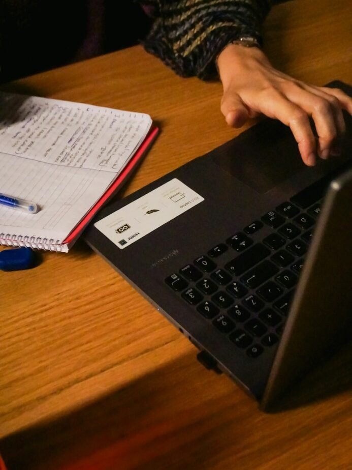 Hotel Accounts Receivable Aging Report: Format & Collection SOP 1 Professional typing on a laptop at a desk