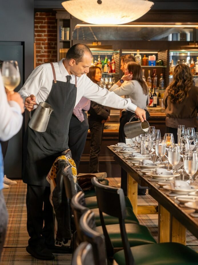 Restaurant Manager Job Description: Duties, Skills & Hiring Checklist 1 Restaurant staff preparing seating for guests